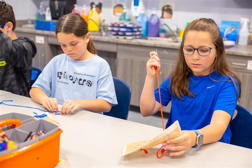 Students learning about embroidery